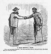 An image of a white man and a black man shaking hands. Both men's left legs have been amputated.