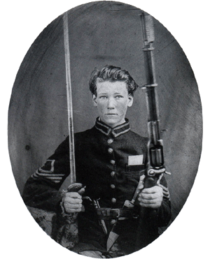 A photo of Lt. Charles S. Powell holding a sword, a Bowie knife, and a rifle