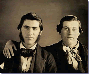 Two men from the nineteenth century; one man has his arm around the other's shoulder
